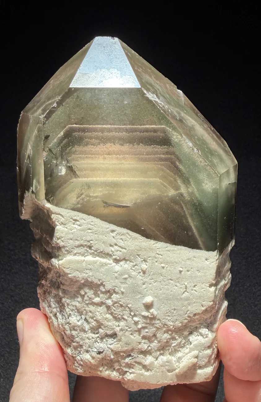 A phantom quartz: the layered ghost of an earlier, smaller termination, sealed inside as the crystal kept growing.
