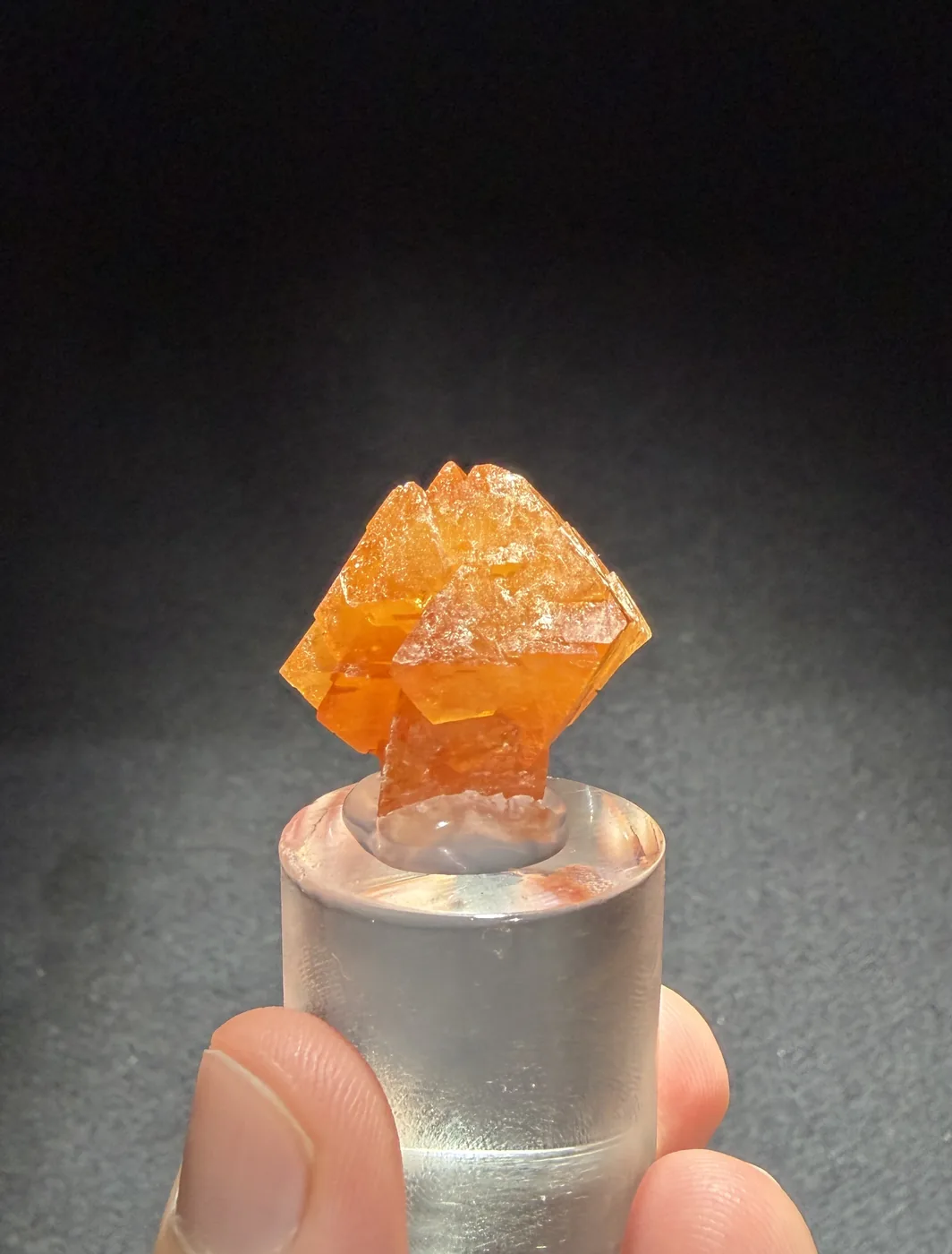 An orange scheelite crystal showing the pseudo-octahedral, bipyramid-like habit. A P&L Art and Crystals specimen.